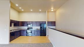 A kitchen with dark wood cabinets and stainless steel appliances.