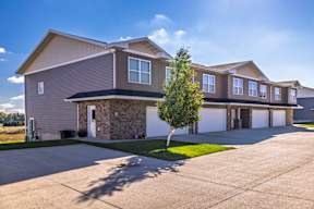 A large house with a driveway in front.