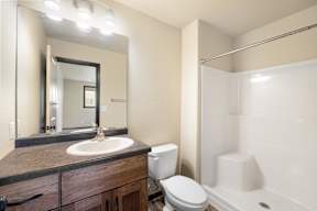 A bathroom with a sink, toilet, and bathtub.