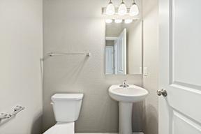 A white toilet and sink in a bathroom.