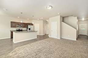 A spacious kitchen with a countertop and cabinets.