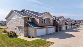 A row of houses with garages in front.