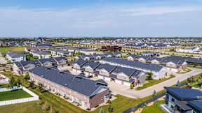 A large housing development with multiple houses and a clear sky.