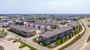 A large residential complex with multiple buildings and a parking lot.