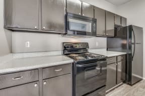 a kitchen with stainless steel appliances and granite countertops