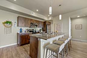 A kitchen with a bar area and stools.