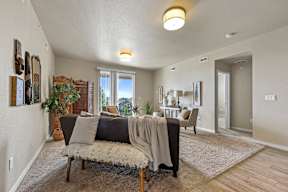 A living room with a couch, chair, and a rug.