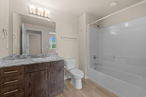 A bathroom with a sink, toilet, and bathtub.