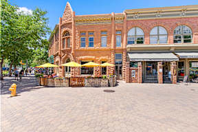 A street view of a building with a bakery on the ground floor.