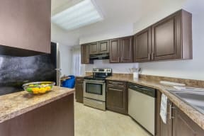 Kitchen with cabinets, sink, stainless steel oven and dishwasher