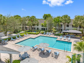 a swimming pool with chairs and umbrellas at the resort