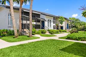 A building with a green lawn in front of it.
