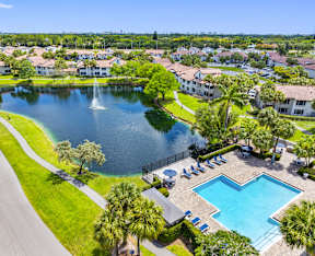 A beautiful aerial view of a residential area with a swimming pool and a fountain.