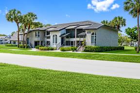 A house with a white front yard and a driveway.