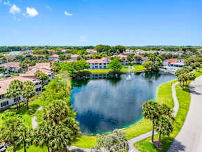 A lake surrounded by houses and trees.