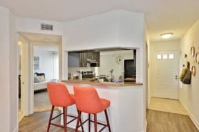 Kitchen bar with two stools looking in toward kitchen