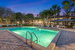 a resort style swimming pool at night at the resort at longboat key club