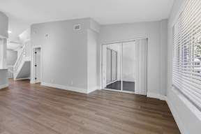 A room with wooden floors and white walls.