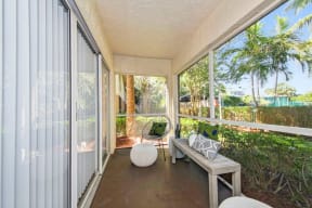 Large screened in patio with chairs and table