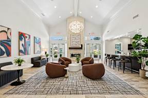 A living room with a fireplace and a chandelier.