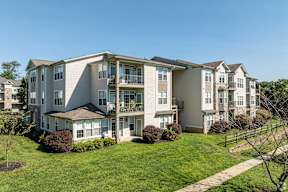 Apartment building with a green lawn in front.
