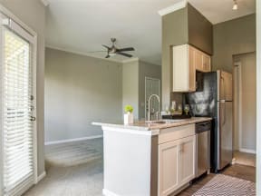 Franklin Apartments for Rent - Harpeth River Oaks - Kitchen with Kitchen Island, Stainless-Steel Appliances, and White Cabinets