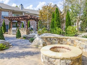 Harpeth River Oaks - Stone Courtyard and Grill Area Surrounded by Lush Landscaping
