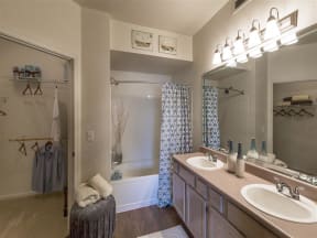 Franklin Apartments - Harpeth River Oaks - Bathroom with Double Sinks, Bathtub and Shower, and Wood-Style Floors