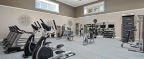 Naperville, IL, Apartments - 803 Corday at Naperville - Spacious Fitness Center With Treadmills, Ellipticals, Strength Machines, Free Weights, And Large Windows.