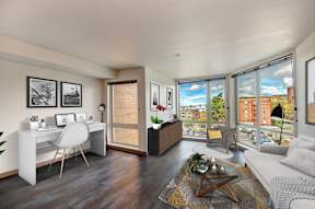Living room with desk and large windows