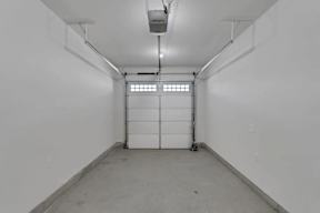 A white room with a door and a window.
