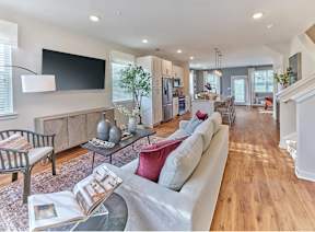 A modern living room with a grey sofa and a coffee table.