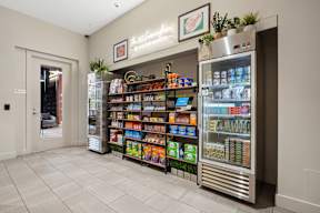 A refrigerator filled with drinks and snacks in a room.