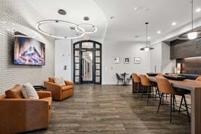 A modern living room with a wooden floor and a white brick wall.