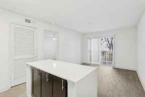 A white kitchen island with a black cabinet and a white countertop.
