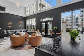 A black and white living room with a large table and chairs.