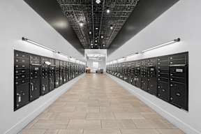 A long hallway with a series of lockers on the wall.