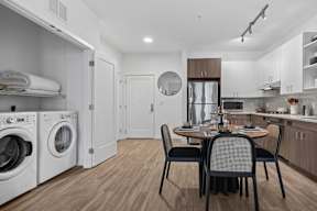 A modern kitchen with a dining table set for four.