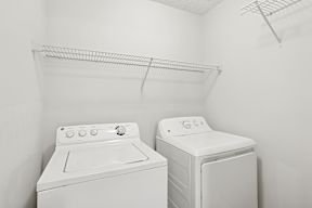 A white washing machine and dryer in a small laundry room.