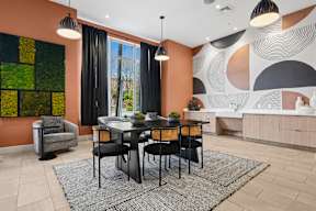 A dining room with a table set for four.
