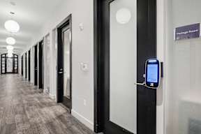 A hallway with doors and a package room sign.