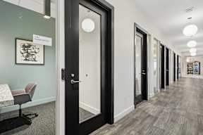 A hallway with a sign that says "1400 Home Office" on the wall.