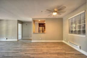 One Bedroom Apartments in Larkspur CA - Larkspur Courts Apartments Living Room with a Ceiling Fan, Wood Flooring, and More