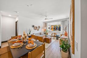 A dining room with a table set for a meal.