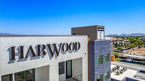 A Harwood sign is displayed on a building.
