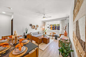 A dining room with a table set for a meal.
