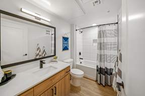 A modern bathroom with a white sink and a white toilet.