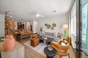 A living room with a brown chair and a white couch.