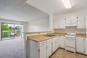 the preserve at ballantyne commons apartment kitchen with white appliances and counter tops