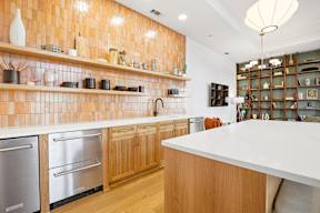 A kitchen with wooden cabinets and a white counter.